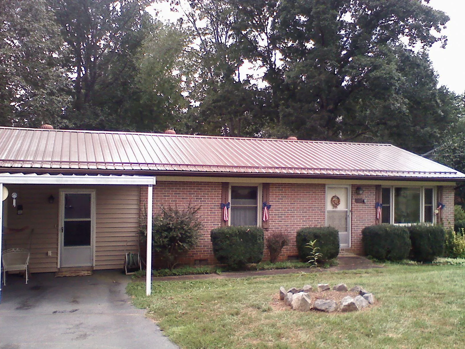 Bronze metal roof and carport on a brick ranch home — Roof Repair work by our crew in White City